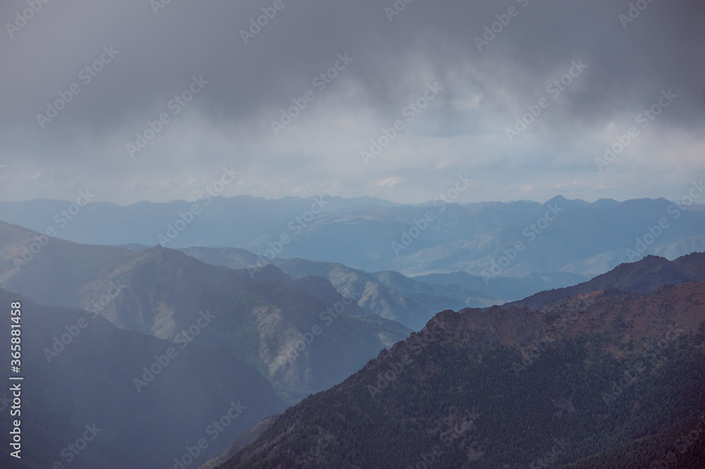rainy clouds against the backdrop of high mountains in the Altai Mountains