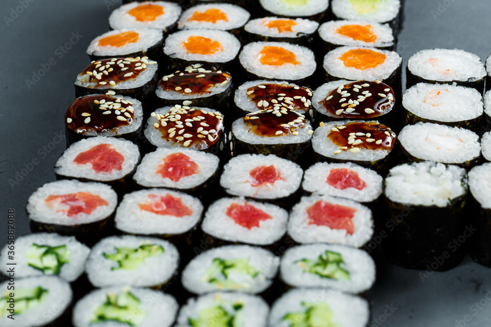 Japanese food. Rolls with ripe avocado, red fish, salmon, fresh rice with vegetables in nori. Set with rolls Japanese food. Rolls with ripe avocado, red fish, salmon, fresh rice with vegetables in nori. Set with rolls
