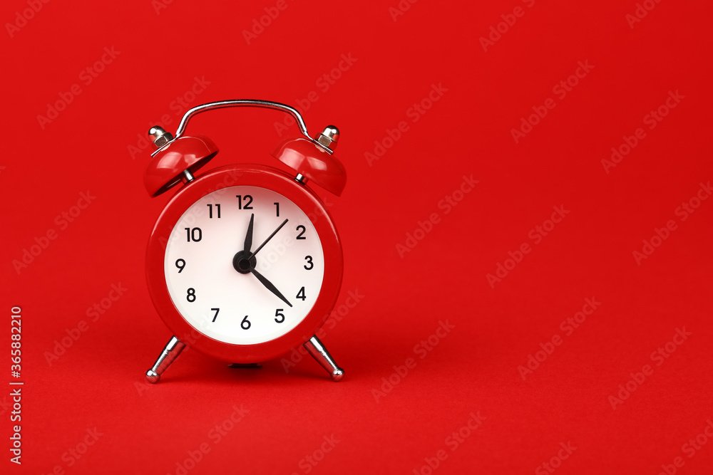 Close up one red alarm clock over red background - obrazy, fototapety, plakaty 