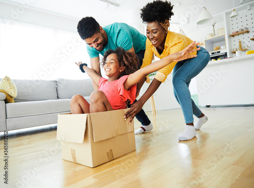  child family father fun mother happy girl happiness daughter box together relocation moving cardboard box