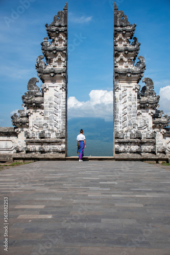 Hindu Lempuyang temple gates Instagram famous location for tourists taking solo photograph with blue background sky in Bali
