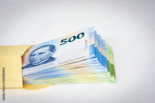 Five hundred mexican pesos money envelop folder stack close up