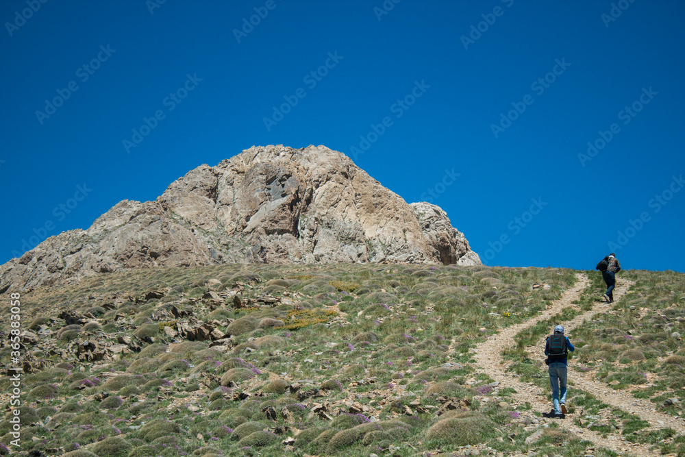 travelers climb to the top of the mountain