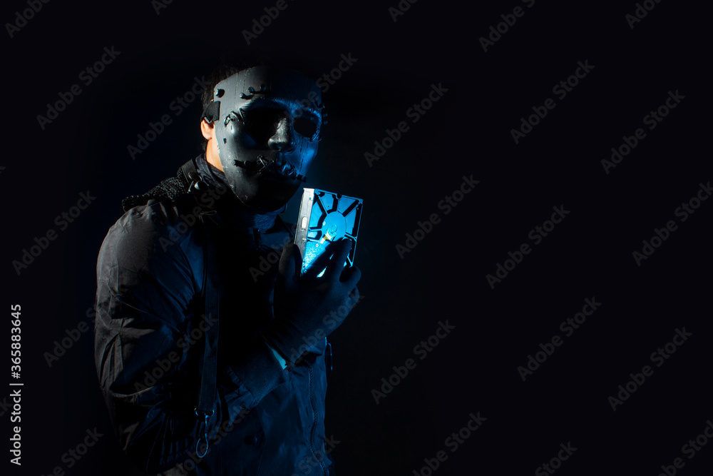hacker robbery terrorist holding the harddisk of virus computer attack to server network system online in data internet security hacker robbery terrorist holding the harddisk of virus computer attack to server network system online in data internet security