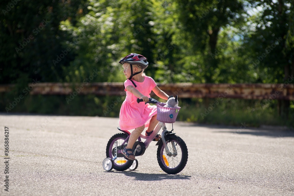 The first bike ride a little girl learns to ride a bicycle. The first bike ride a little girl learns to ride a bicycle.