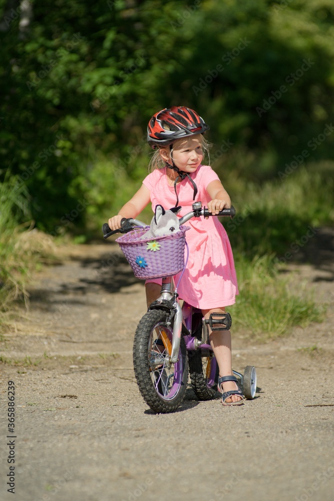 The first bike ride a little girl learns to ride a bicycle. The first bike ride a little girl learns to ride a bicycle.