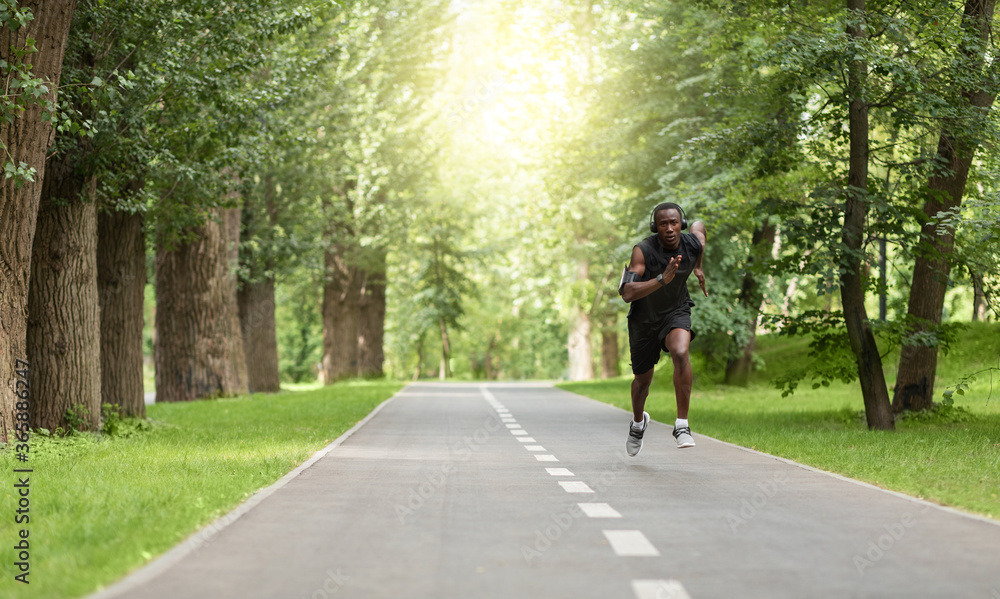 Black man jogger training at park, getting ready for marathon