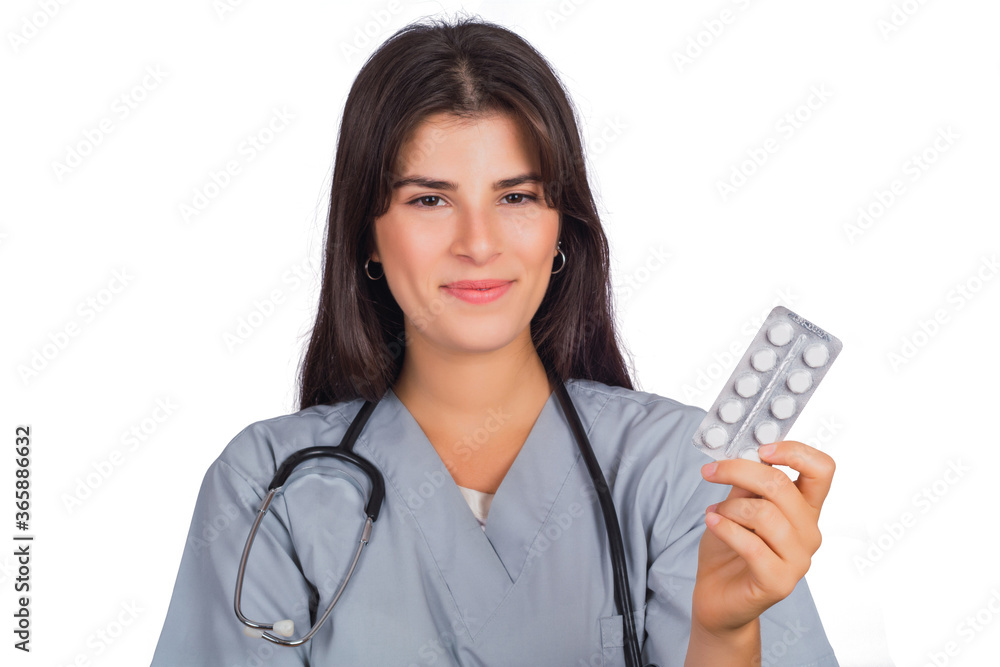 Female doctor with stethoscope and holding pills. Female doctor with stethoscope and holding pills.