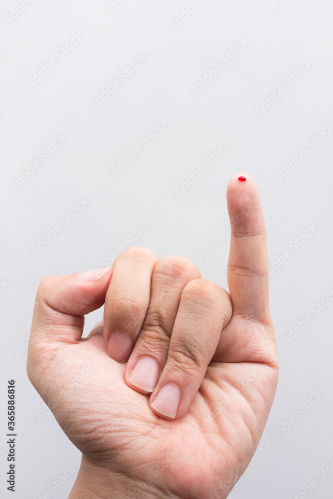 Blood drop on fingertip prepare for checking the glucose level with a glucometer for examining diabetes mellitus. Blood drop on fingertip prepare for checking the glucose level with a glucometer for examining diabetes mellitus.