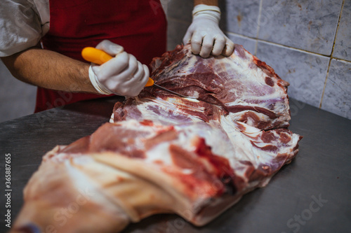 the butcher cuts and processes the meat