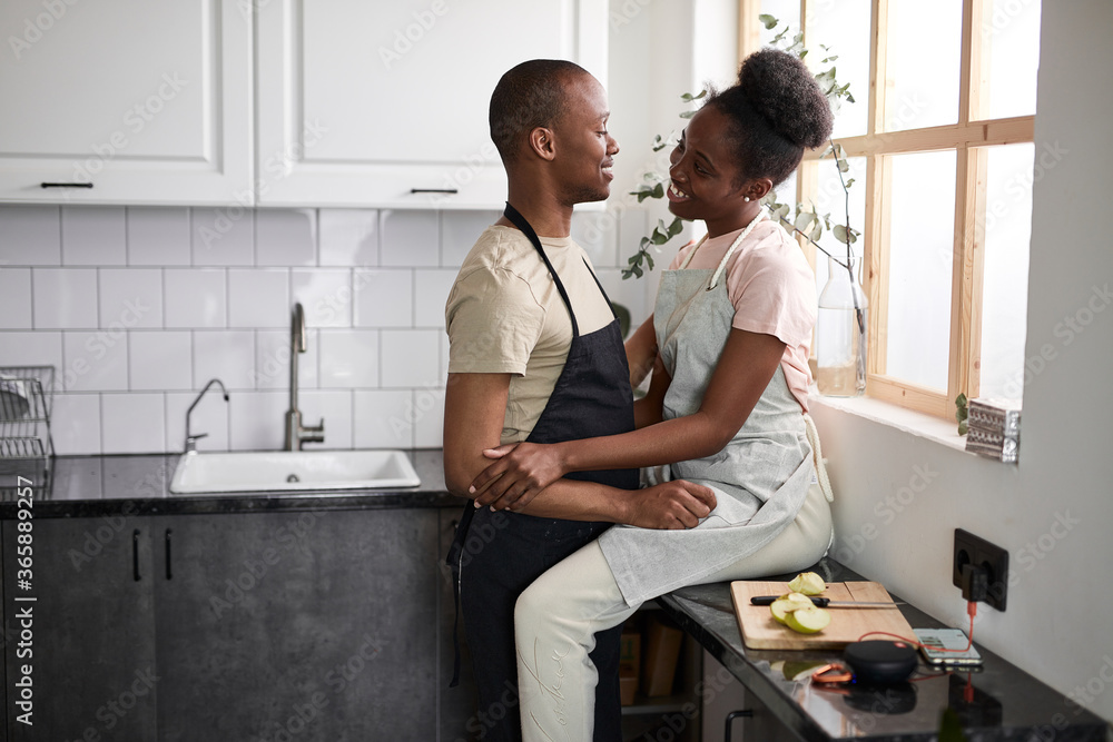 beautiful young couple have rest in the kitchen, enjoy cooking together, free time at home, in love