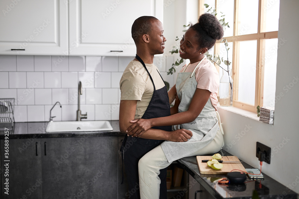 beautiful young couple have rest in the kitchen, enjoy cooking together, free time at home, in love beautiful young couple have rest in the kitchen, enjoy cooking together, free time at home, in love