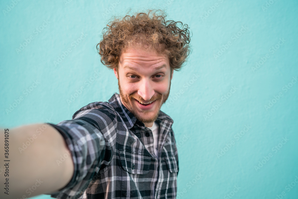 Young man taking a selfie.