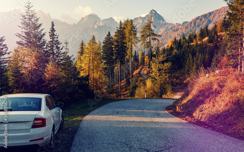 Awesome alpine highlands in sunny day. Road Trip Concept, Car Driving Travel in Fall and Autumn Season, Lake, beautiful Foliage and Mountains as background. Julian Alps. Slovenia. Creative image
