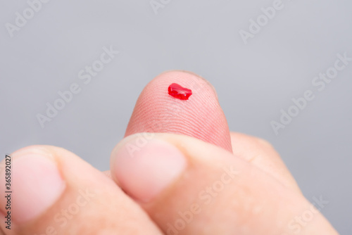 Blood drop on fingertip prepare for checking the glucose level with a glucometer for examining diabetes mellitus. photo