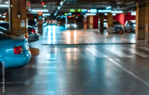 Garage interior blurred. Car lot parking space in underground city garage. Empty road asphalt background in soft focus. Large private garage.