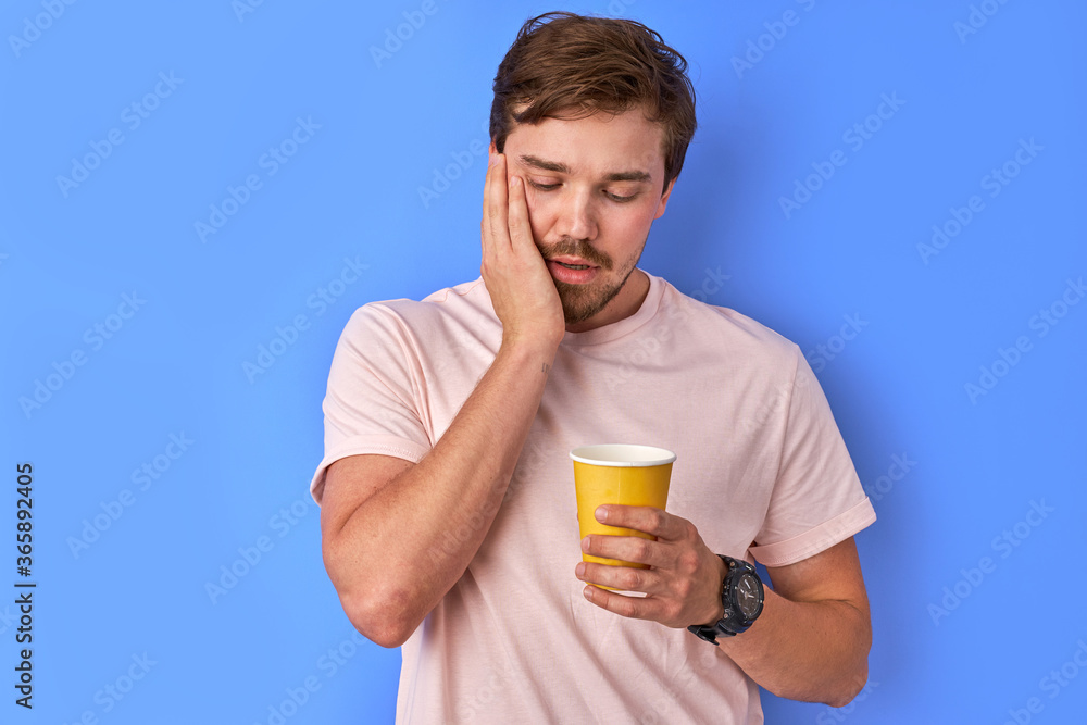 exhausted man thinks when is it all over, he is tired, look at cup of coffee with sadness and touch the face. feel hopelessness exhausted man thinks when is it all over, he is tired, look at cup of coffee with sadness and touch the face. feel hopelessness
