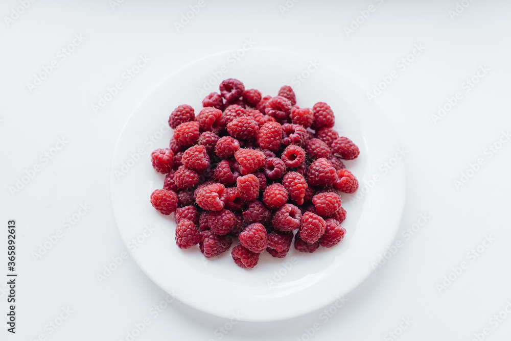 Red raspberry berries close-up on a white background. Healthy food, natural vitamins. Fresh berries Red raspberry berries close-up on a white background. Healthy food, natural vitamins. Fresh berries