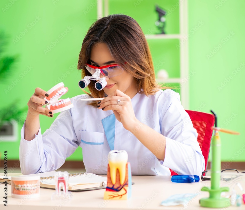 Woman dentist working on teeth implant Woman dentist working on teeth implant