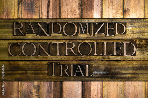 Randomized Controlled Trial text formed with real authentic typeset letters on vintage textured silver grunge copper and gold background