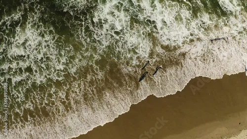 Kids playing in ocean drone