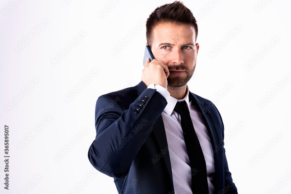 Businessman having a call while standing at isolated white background Businessman having a call while standing at isolated white background