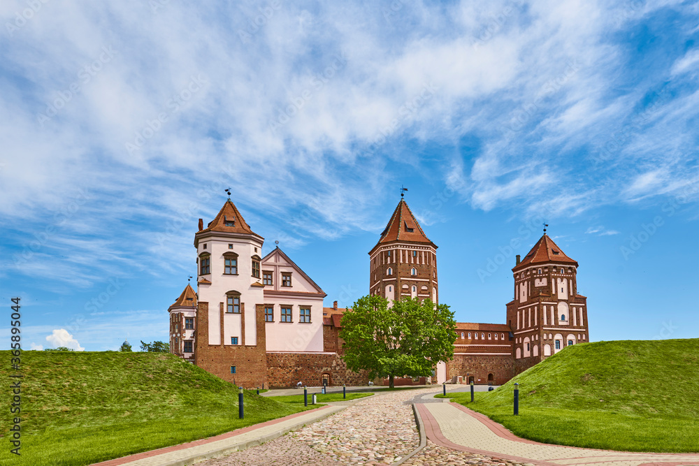 Fototapeta premium Mir castle complex in summer day with blue cloudy sky. Tourism landmark in Belarus, cultural monument