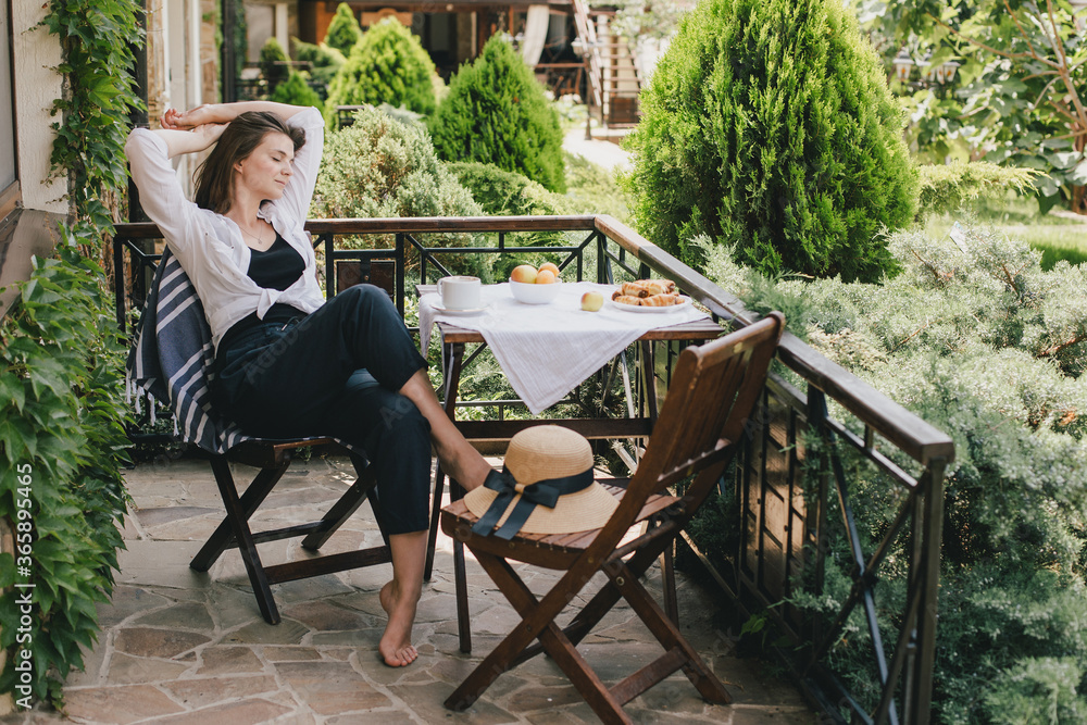 custom made wallpaper toronto digitalYoung woman drinking tea on cozy terrace of a wooden country house with beautiful yard view.