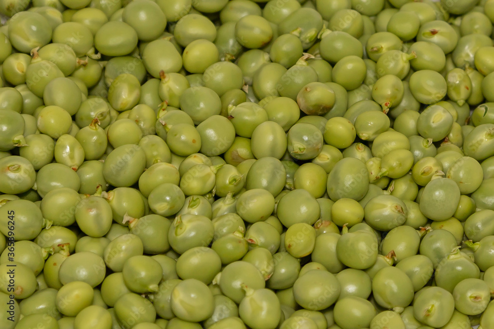 Fresh green peeled peas. The peas are sprinkled on top of each other. Fresh green peeled peas. The peas are sprinkled on top of each other.