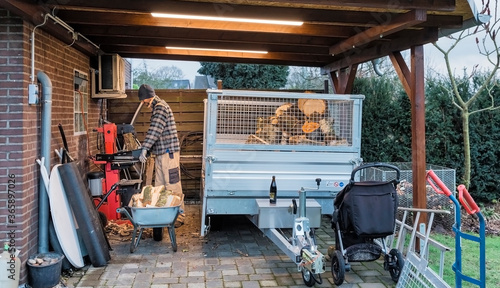 Man cutting firewood with wood splitter