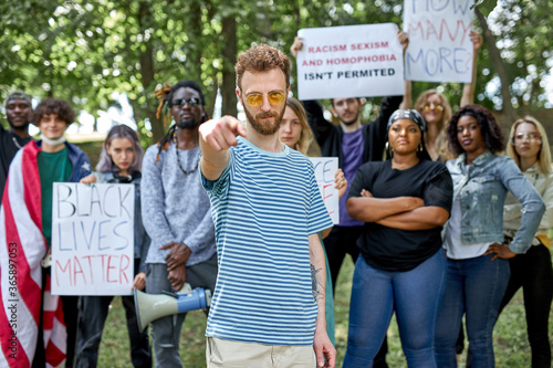 Black Lives Matters protesters or activists in holding signs and marching outside. diverse people demonstrate their dissatisfaction with situation in America connected with killing black people