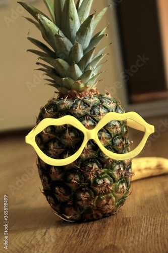 Lovely mister Pineapple.Pineapple fruits with yellow eyeglasess photo