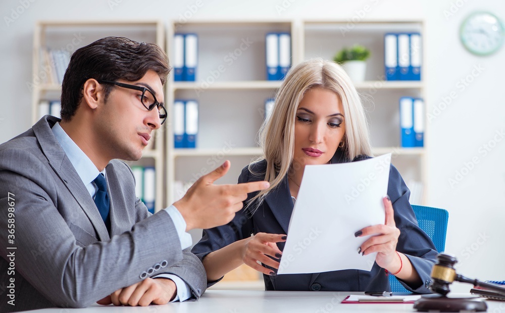 Lawyer discussing legal case with client Lawyer discussing legal case with client