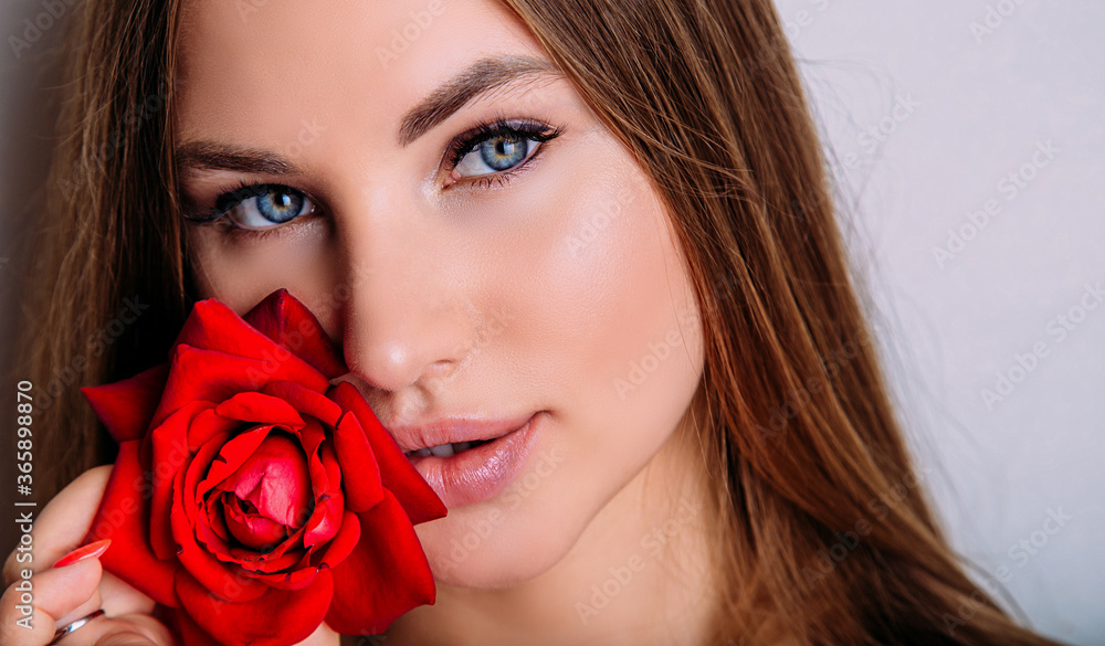 close-up portrait of beautiful model woman with red rose in her hand close-up portrait of beautiful model woman with red rose in her hand
