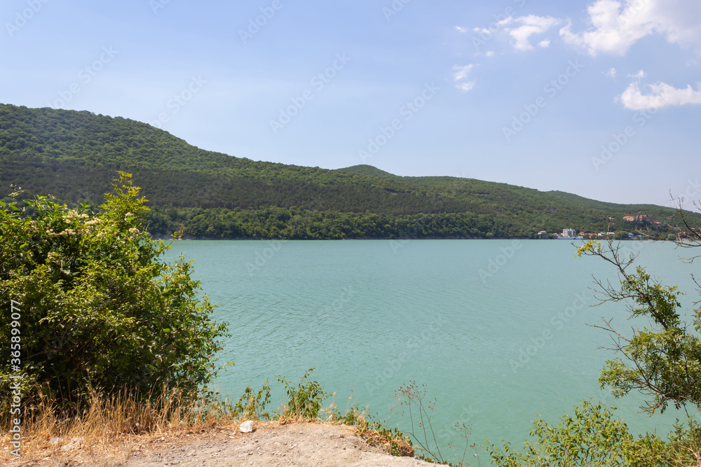 azure lake view from the cliff, in the background of the mountain with the forest