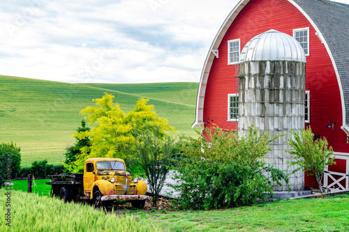 Classic red barn and orange pickup photo