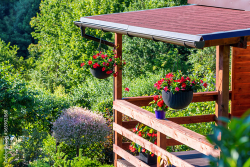 Fototapeta Naklejka Na Ścianę i Meble -  The garden wooden house decorated with summer flowers