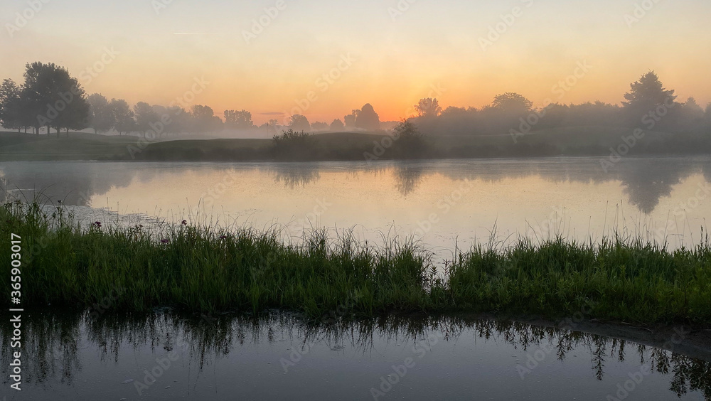 sunrise foggy morning on the golf course pond reflections