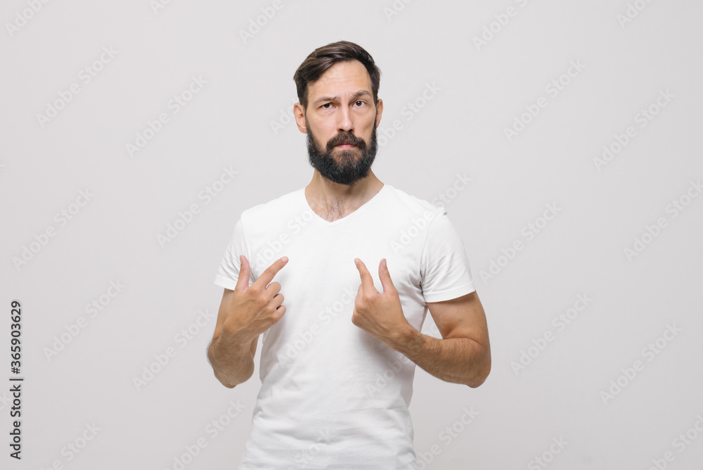 A young Caucasian guy points fingers at himself. A young Caucasian guy points fingers at himself.