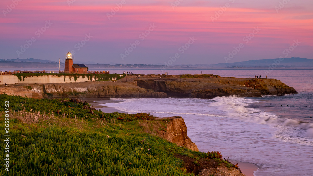 December 27, 2019, USA, Santa Cruz light house landscape at sunset, with pink and purple skies , Pacific Ocean waves crushing on the cliffs, California coastline background .