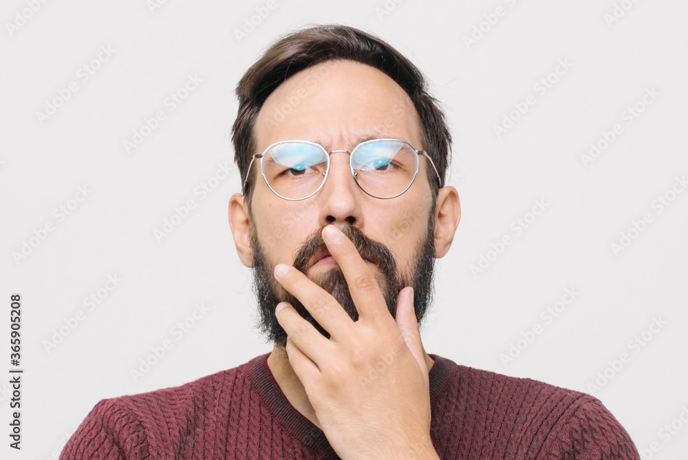 pensive young man in a burgundy sweater in the studio on a white background pensive young man in a burgundy sweater in the studio on a white background