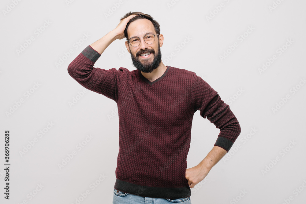 smiling young man in a burgundy sweater in the studio on a white background smiling young man in a burgundy sweater in the studio on a white background