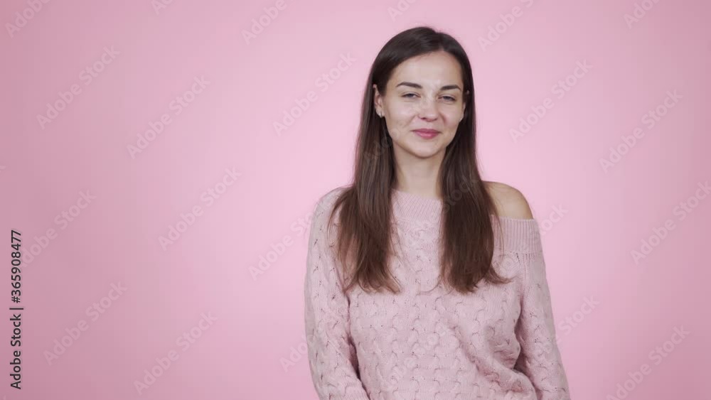 Girl in knitted sweater shows ok gesture, great sign isolated on pink background Girl in knitted sweater shows ok gesture, great sign isolated on pink background