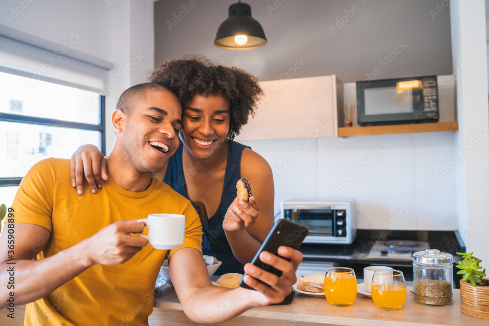 Young couple taking selfie while having breakfast at home. Young couple taking selfie while having breakfast at home.