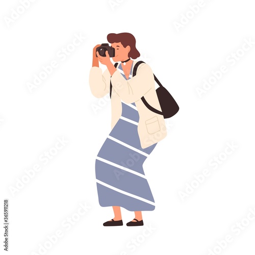 Smiling woman in trendy dress taking photo holding camera vector flat illustration. Happy female photographing enjoying hobby isolated on white. Cute girl amateur photographer with backpack