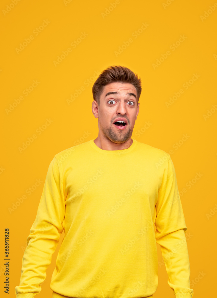 Surprised young man in yellow clothes Surprised young man in yellow clothes