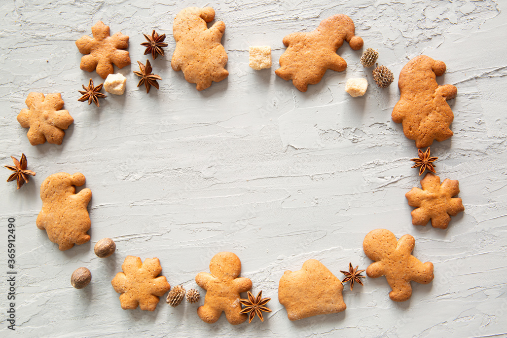 Homemade festive gingerbread cookies on grey concrete, copy space.