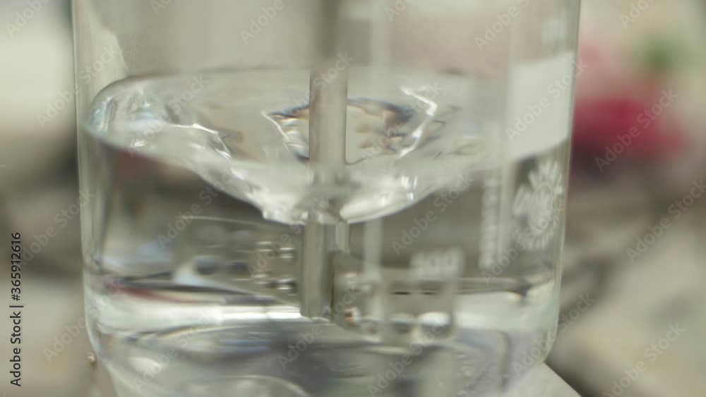 liquid being mixed in laboratory glassware slow motion liquid being mixed in laboratory glassware slow motion