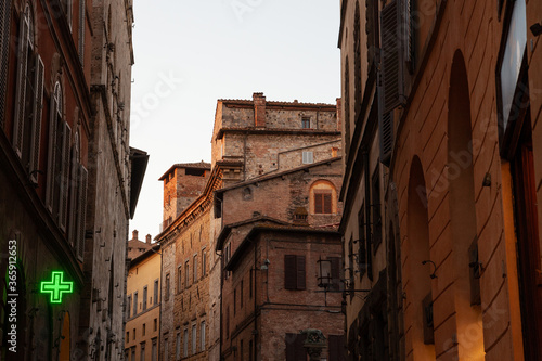 Siena, Italy - 12/09/2013: Warm colors of a street of medieval Siena Tuscany