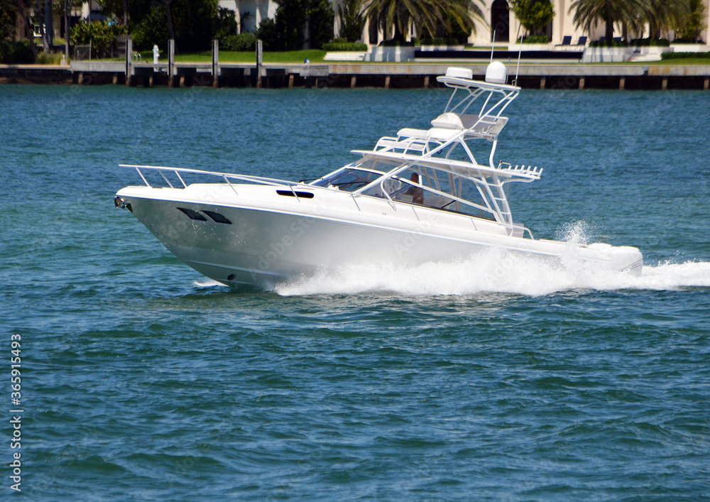 White sport fishing boat with tuna tower on the Florida Intra-Coastal off of Miami Beach. White sport fishing boat with tuna tower on the Florida Intra-Coastal off of Miami Beach.